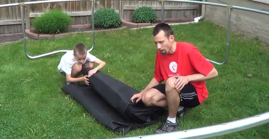 2 mens are assembling trampoline.